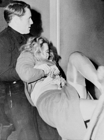 15 Jan 1943, Los Angeles, California, USA --- Actress Frances Farmer battles officers seeking to take her to jail cell after her arrest as a parole violator. Officer T.W. MacDonald is shown with the struggling actress. --- Image by © Bettmann/CORBIS