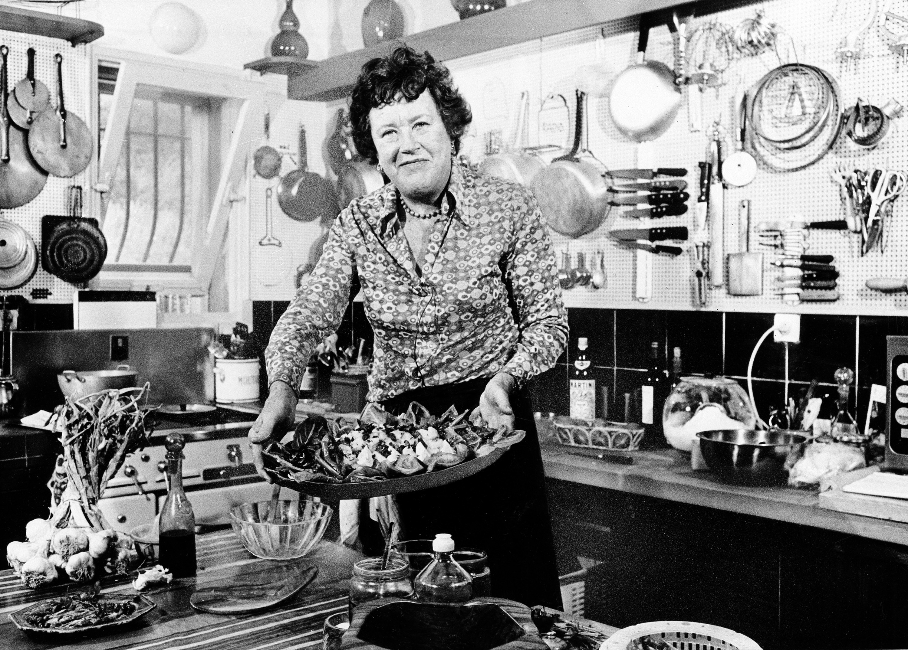 FILE - In this Aug. 21, 1978, file photo, American television chef Julia Child shows a salade nicoise she prepared in the kitchen of her vacation home in Grasse, southern France. Child changed the way Americans look at food as well as the way women looked at cooking and themselves. (AP Photo, File) 08092012xBRIEFING